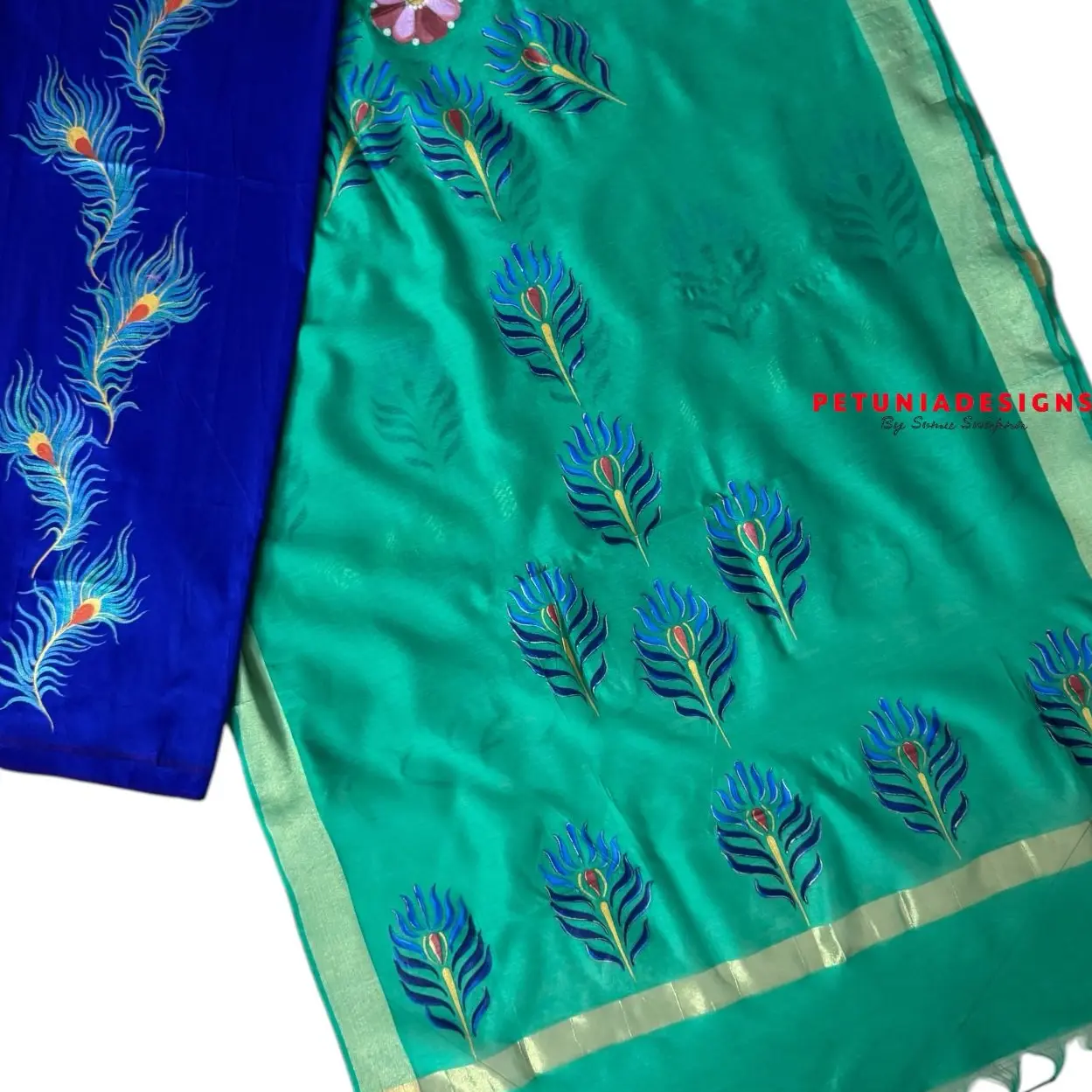 Vibrant Unstitched Fabric with Peacock Motif for Dresses Vibrant unstitched hand-painted dress material for men and women.